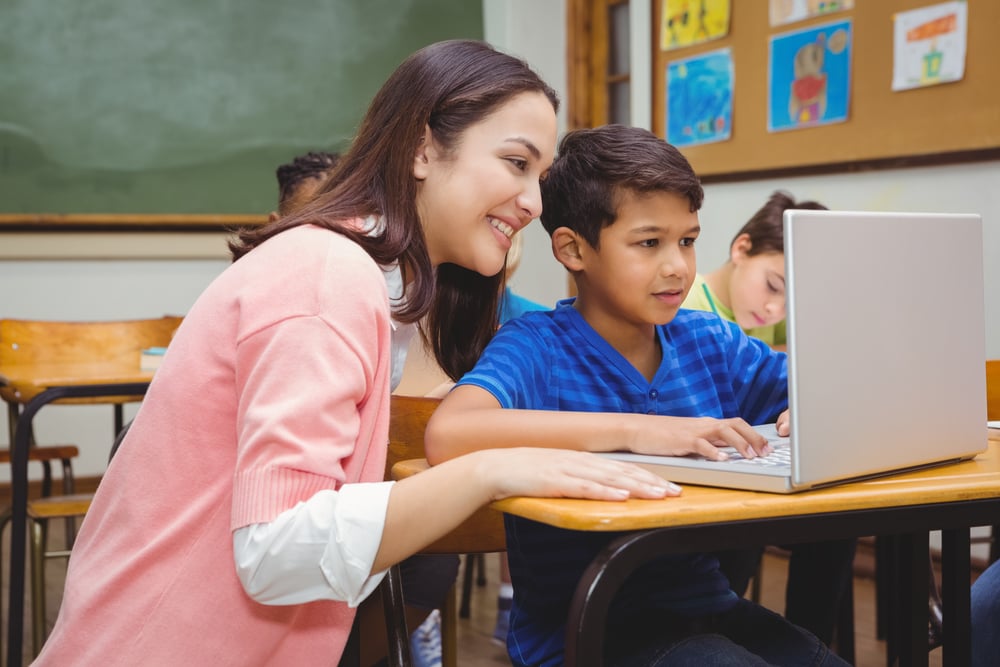 happy-teacher-using-laptop